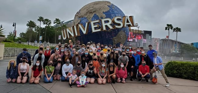 Travelers in front of Universal Studios globe sign
