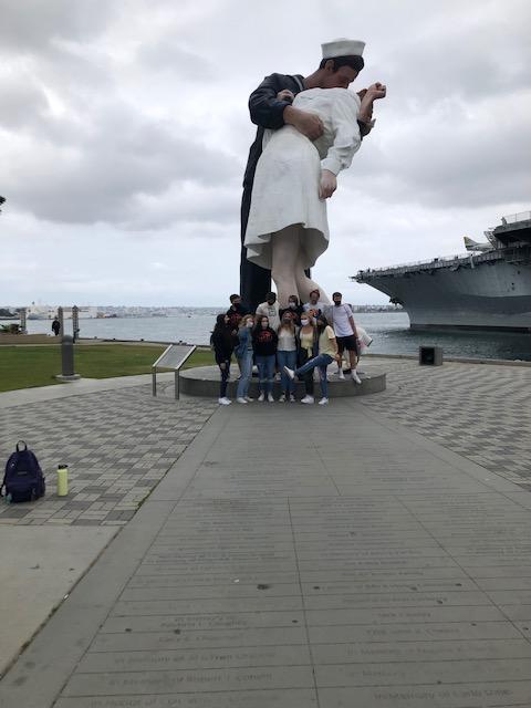 Students posing with statue in San Diego