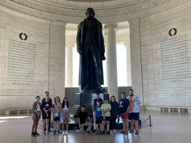 Travelers with Washington, D.C. monument