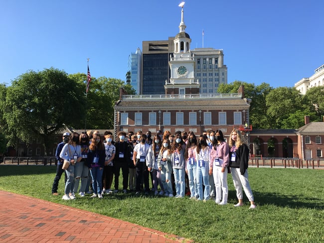 Group of students posing in front of building