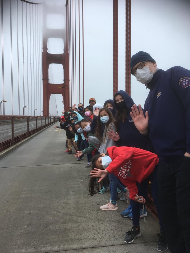 Group posing for photograph on bridge