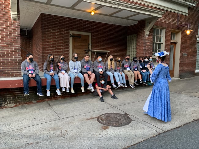 Colonial woman with student group